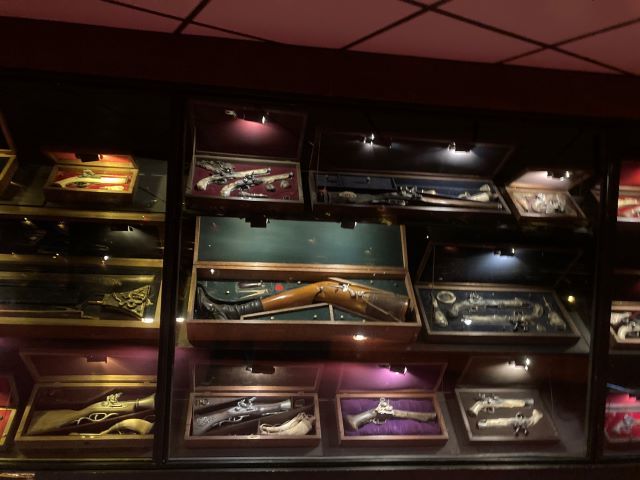 Some guns. One of them is a woman's wooden prosthetic leg with a gun built into the side.